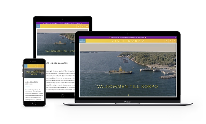 Mockup of Visit Korpo webpage with laptop, tablet and phone devices.