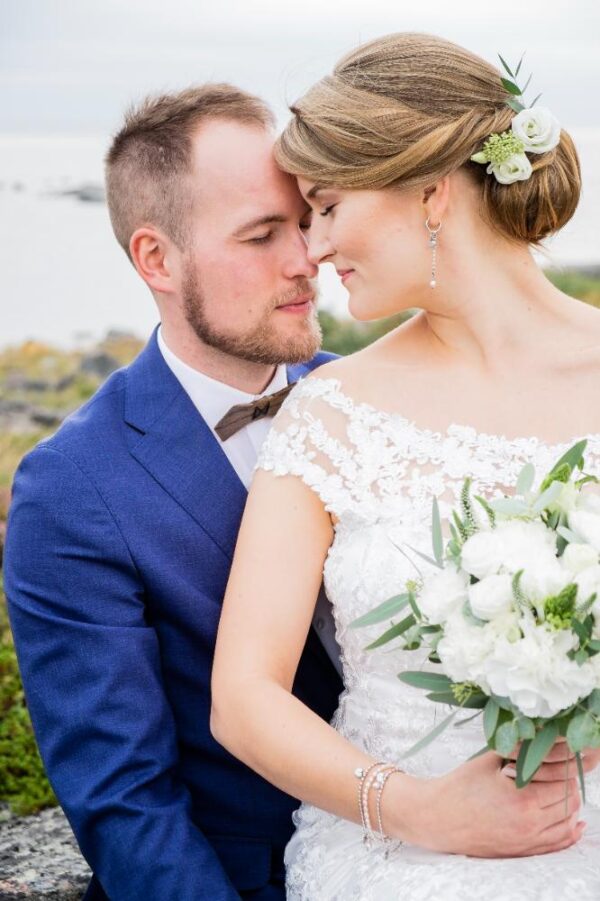 A wedding couple with their foreheads together, enjoying a moment of calm.