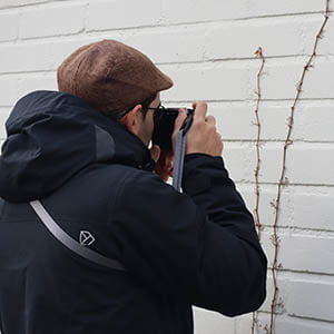 Aarón taking pictures of a detail on the wall.