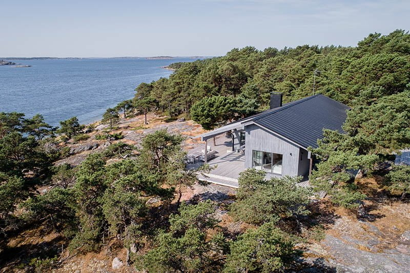 A drone view of a summer residence by the sea.