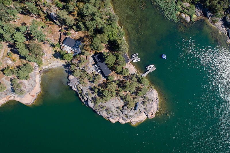 A drone’s view of a summer cottage overlooking the sea.