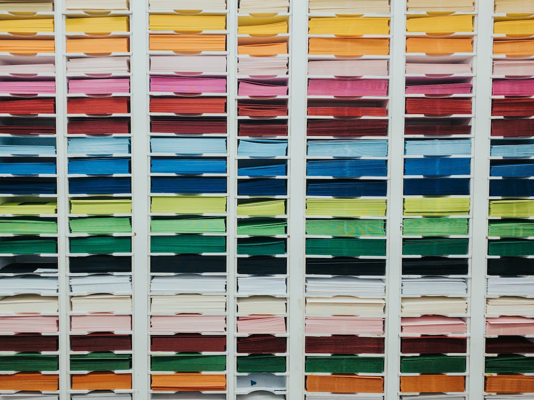 An image of many colored a4 papers organized in trays